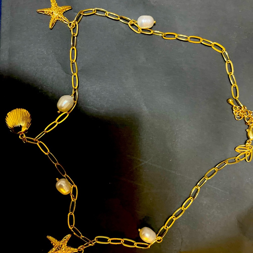 Gold and pearl necklace with beach theme charms